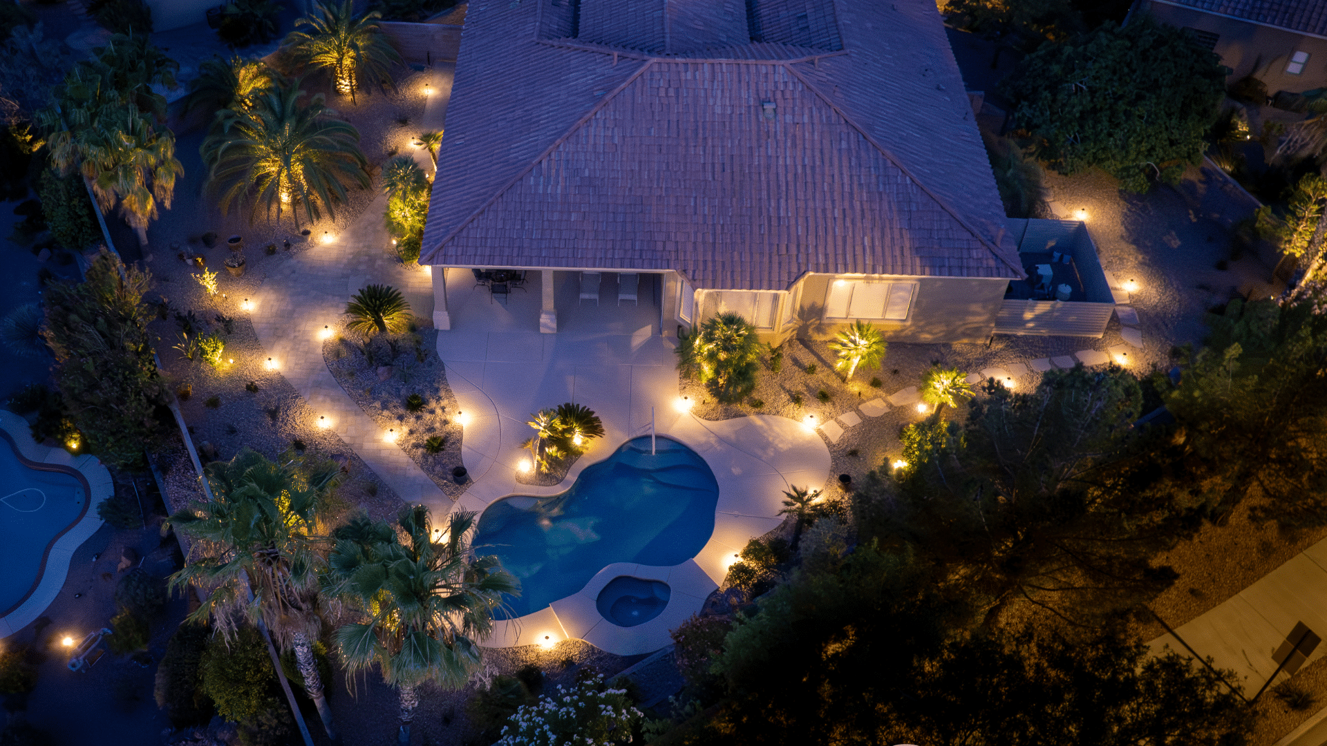 Various landscape design features, including outdoor patios, pools, and artificial grass, showcasing landscaping and hardscaping services by Visualized Landscape